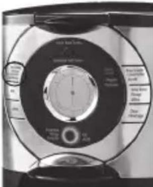 Close-up of a circular electronic device with labeled components and a central dial indicator.