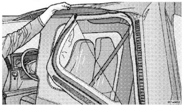 Technical illustration of a car interior showing dashboard, steering wheel, and seatbelt (no text or symbols)