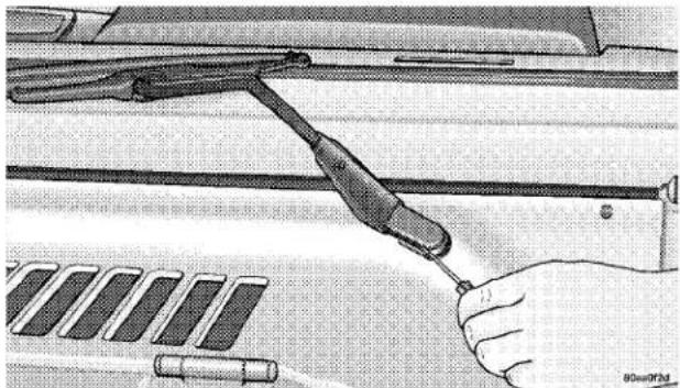 Illustration of a hand holding a tool interacting with a vehicle, no text or symbols present