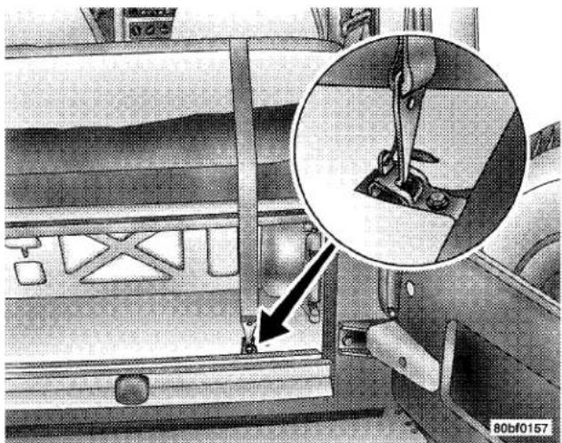 Interior view of a vehicle showing a mechanical assembly with an inset close-up of a component detail (no visible text or symbols)