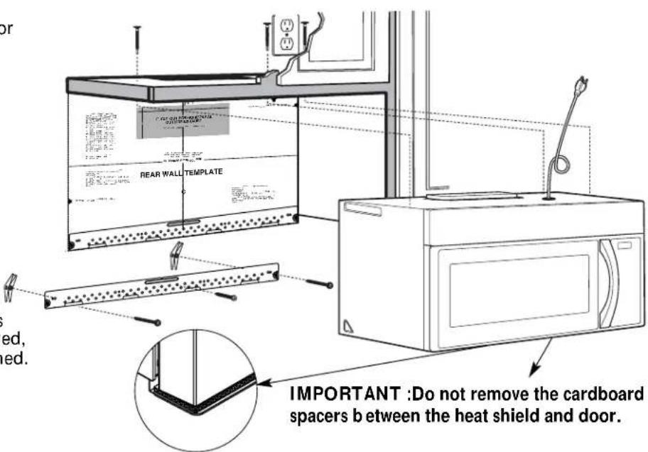 OR REAR WALL TEMPLATE IMPORTANT :Do not remove the cardboard spacers b between the heat shield and door.