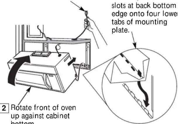 slots at back bottom edge onto four lower tabs of mounting plate. 2 Rotate front of oven up against cabinet bottom.