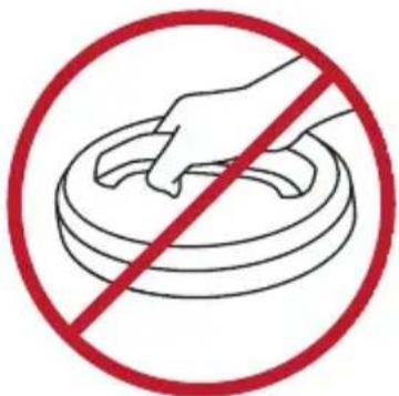 Prohibition sign with hand holding a circular object, enclosed in red circle