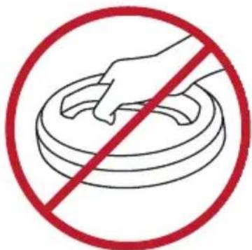 Prohibition sign with hand holding a circular object, crossed out by red circle