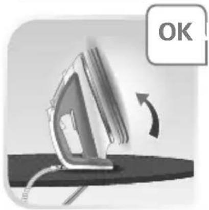 Electric iron on a surface with a circular arrow indicating rotation (no text or symbols)