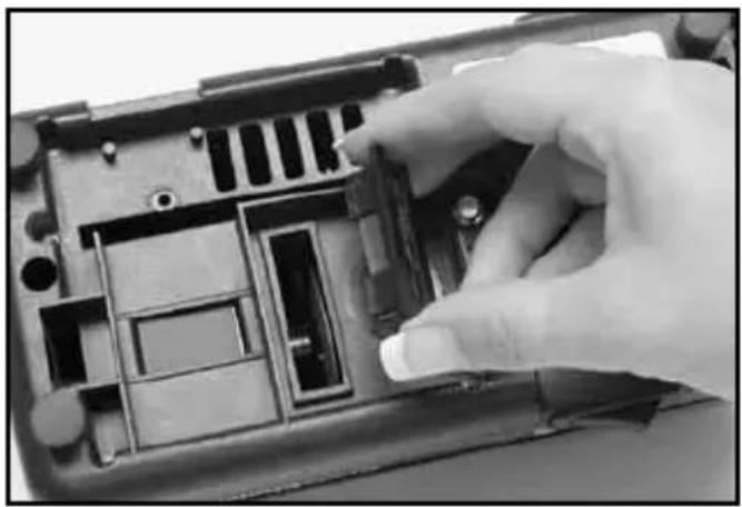 Close-up of a hand inserting a component into a device casing (no visible text or symbols)