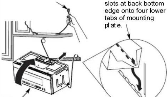 slots at back bottom edge onto four lower tabs of mounting pl at e.
