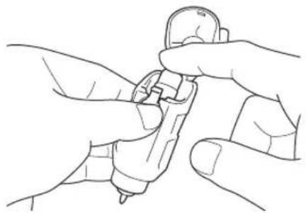Line drawing of two hands holding a small mechanical component (no text or symbols)