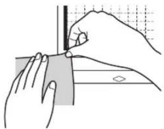 Illustration of hands using a tool to cut a rectangular object with a grid background (no text or symbols)
