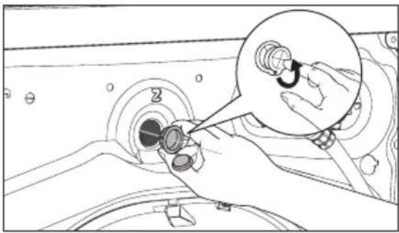 Line drawing of a hand inserting a component into a device with a magnified inset showing the internal mechanism (no text or symbols)