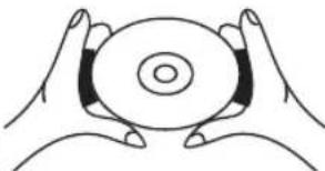 Illustration of two hands holding a circular object with concentric rings (no text or symbols)
