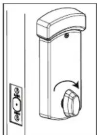 Line drawing of a door handle with a rotary knob and side panel (no text or symbols)