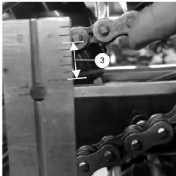 Black-and-white photo of a mechanical assembly with numbered components and measurement indicators