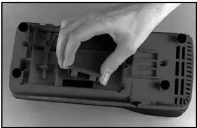 Hand placing a component into a black plastic housing (no visible text or symbols)