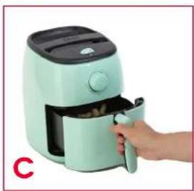 Hand holding a light green air fryer with a black handle, no visible text or symbols on the device itself.
