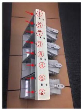 Diagram of a multi-layered electronic device with numbered components and red arrows indicating directional flow or assembly.
