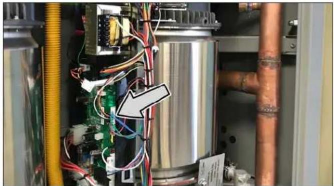 Industrial equipment setup with copper pipes, wiring, and electronic components (no visible text or symbols)