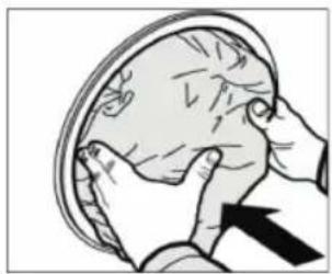 Illustration of a person performing a medical or anatomical task on a circular object, with an arrow indicating direction (no text or symbols present)