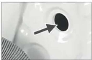 Close-up of a circular object with an arrow pointing to it, possibly part of a mechanical or electronic component (no text or symbols visible)