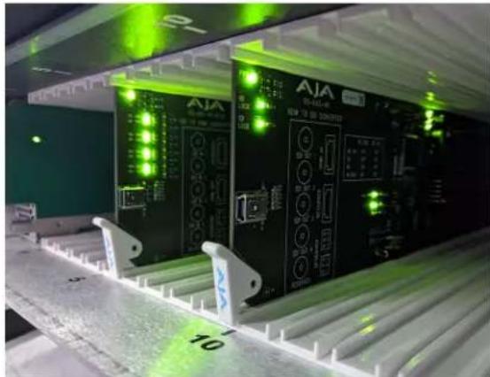 Industrial control panel with green indicator lights and labeled components, no readable text or symbols