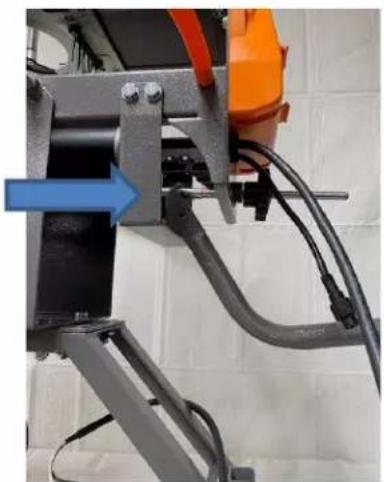 Close-up of a mechanical device with orange and blue components, no visible text or symbols