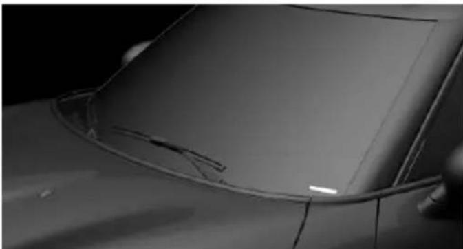 Close-up of a car's front wheel and side panel, showing visible cracks and a small white mark (no text or symbols)