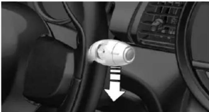Interior view of a car showing the wheel and seatbelt with a directional arrow (no text or symbols)