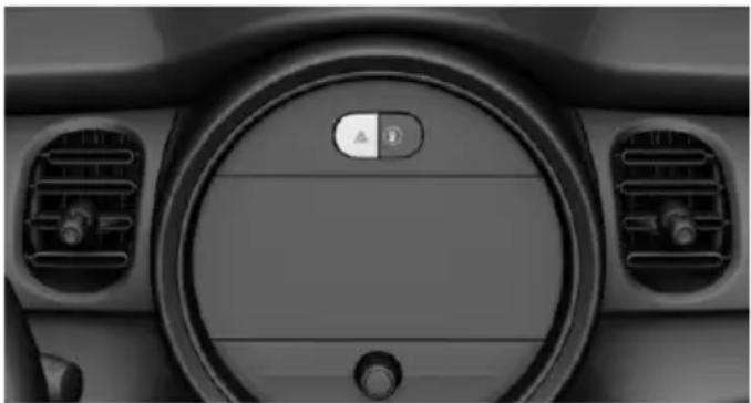Interior view of a car dashboard with circular dial and control buttons (no visible text or symbols)