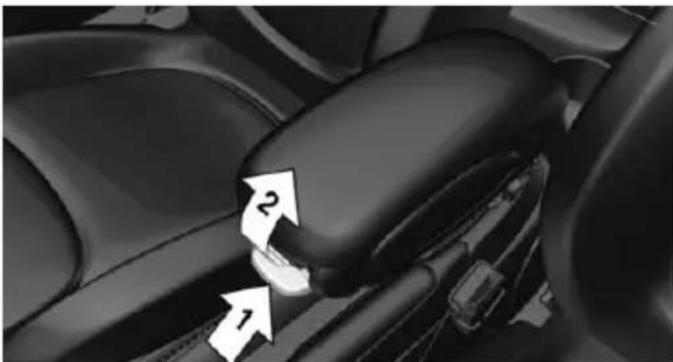 Close-up of a car seatbelt mechanism with numbered arrows indicating specific components (no text or symbols present)