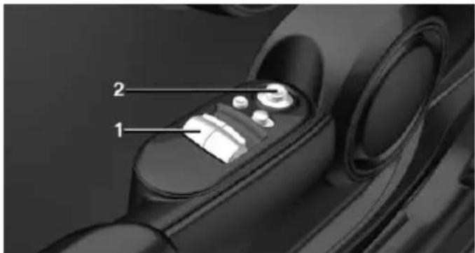 Diagram of a car interior showing labeled parts 1 and 2, likely indicating parts of the dashboard or steering wheel.
