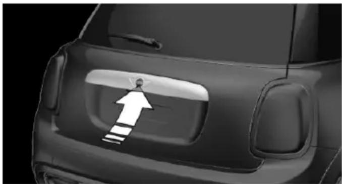 Side view of a car's rear bumper with a white arrow pointing to the side panel (no text or symbols visible)