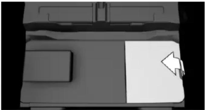 Top-down view of a vehicle's front compartment with a white arrow pointing to the side panel (no text or symbols visible)