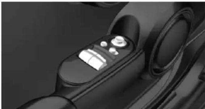 Close-up of a car interior control panel with buttons and a lid (no visible text or symbols)