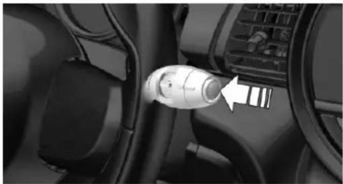 Close-up of a car interior showing a white connector inserted into a vehicle's seatbelt (no visible text or symbols)