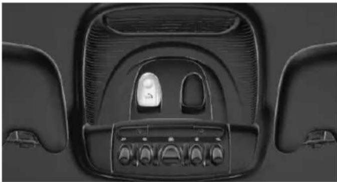 Top-down view of a car dashboard with control knobs and a central illuminated component (no visible text or symbols)