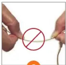 Close-up of hands holding a string with a red prohibition symbol, likely indicating no chemical reaction or doping.