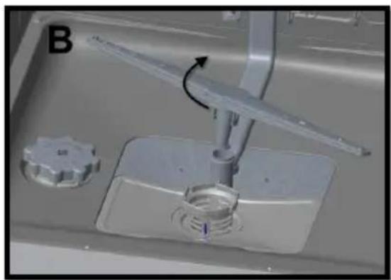 Close-up of a kitchen sink with a tool and a circular component, no visible text or symbols