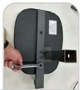 Hand holding a black mechanical device with a handle, no visible text or symbols