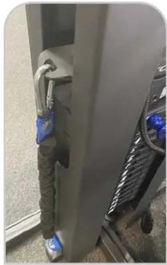 Interior view of a vehicle or industrial space with a blue tag attached to the door (no visible text or symbols)