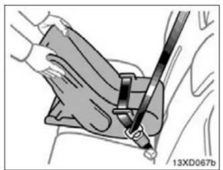 Medical procedure illustration showing a hand holding a medical device with a tool inserted (no text or symbols visible)