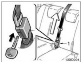 Diagram showing car seatbelt buckle adjustment with labeled parts and directional arrows