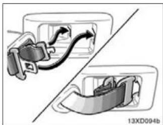 Diagram showing two car seatbelt buckle designs with arrows indicating movement (no text or symbols)