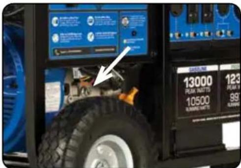 Close-up of a vehicle tire mounted on a gas station with digital display showing engine controls and price tags