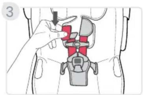 Medical illustration showing a hand adjusting a red device within a vehicle seatbelt, with a black arrow indicating the process.