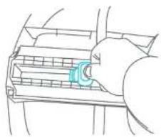 Line drawing of a hand inserting a component into a fan (no text or symbols)