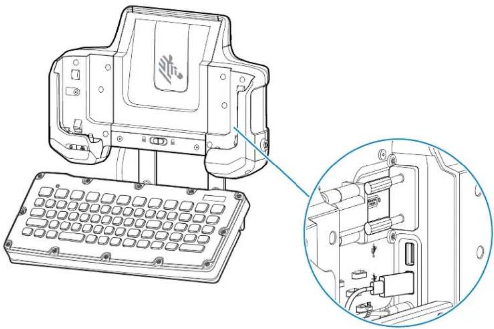 Technical line drawing of a computer chassis with an open keyboard and internal components, showing a close-up inset (no text or symbols)