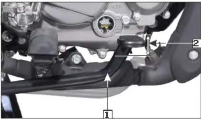 Technical diagram of a mechanical assembly with labeled parts 1 and 2, showing components like gears, springs, and adjustment knobs.