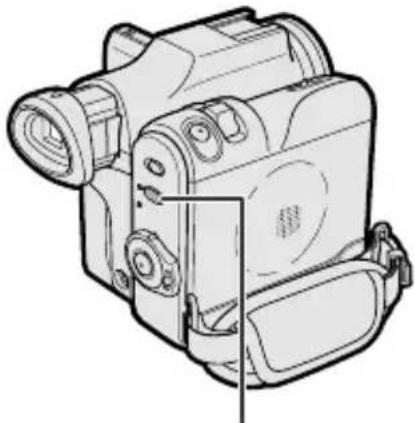 Line drawing of a digital camera with lens and control panel (no text or symbols)
