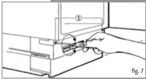Line drawing of a hand inserting a component into a device (no text or symbols present)