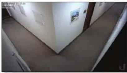 Interior hallway view showing a curved corridor with walls and ceiling, no visible text or symbols